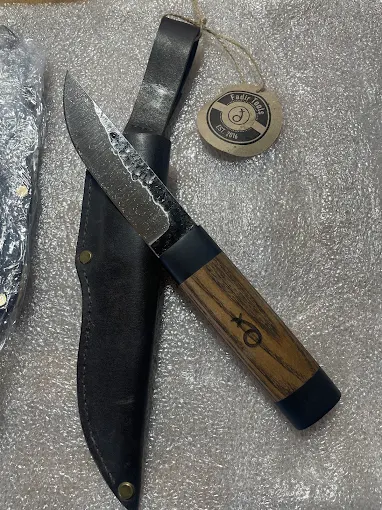 A hand-finished hunting knife with leather sheath